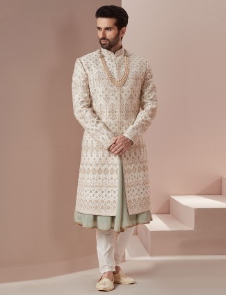 Cream and green raw silk groom wear sherwani